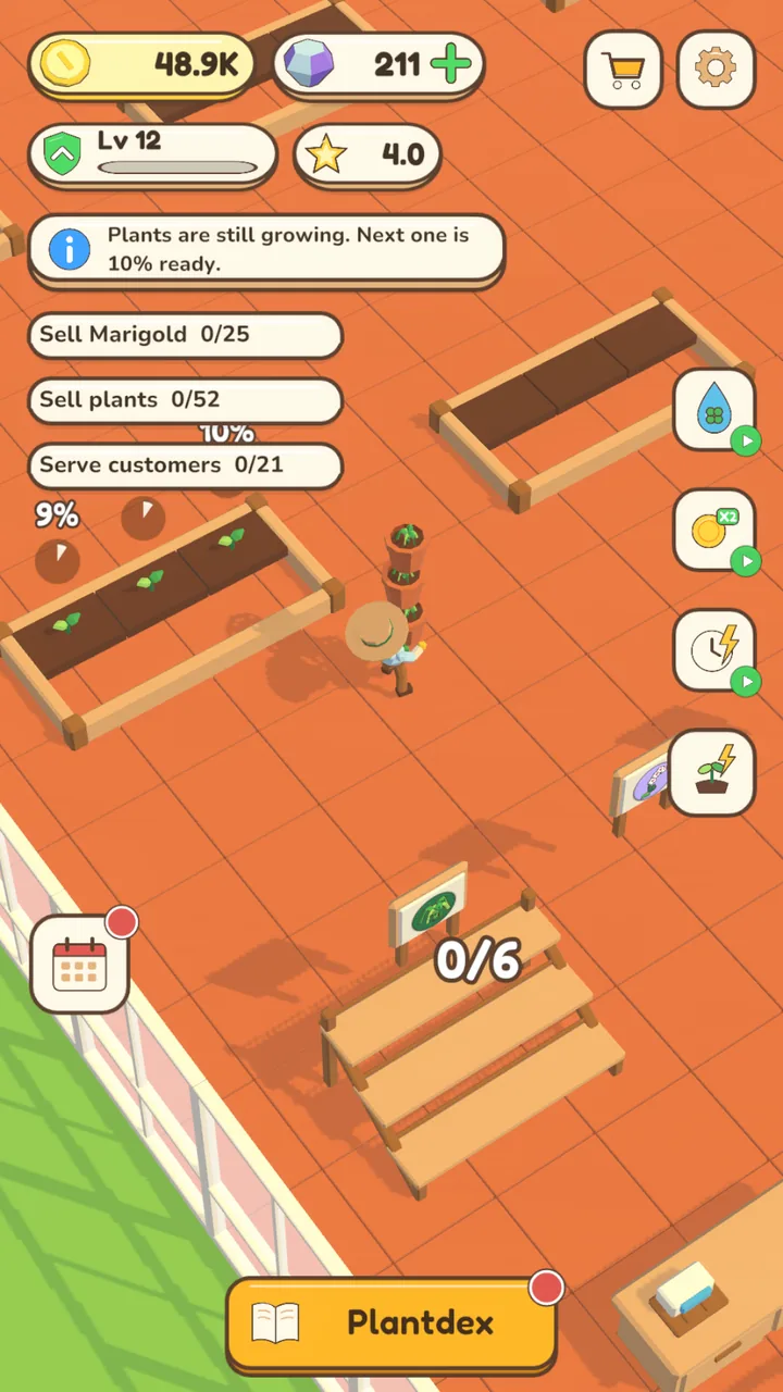Inside the greenhouse: terracotta floor, glass walls and fresh garden beds
